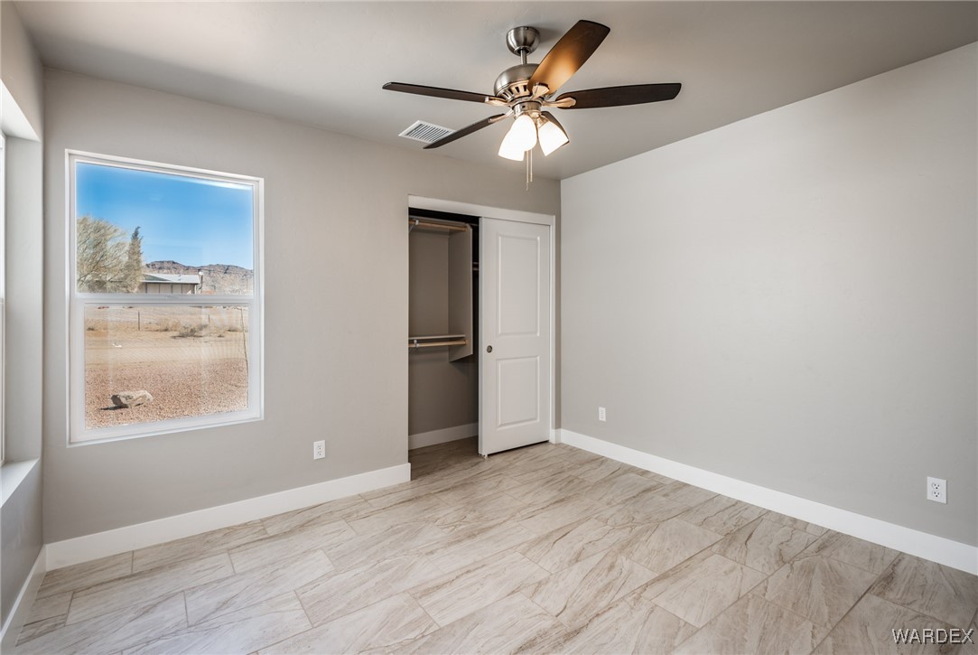 3355 North Bryce Road Golden Valley, AZ 86413 - Photo 7 of 31 a view of an empty room with a window