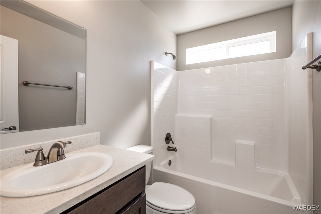 3355 North Bryce Road Golden Valley, AZ 86413 - Photo 8 of 31 a bathroom with a sink toilet and shower