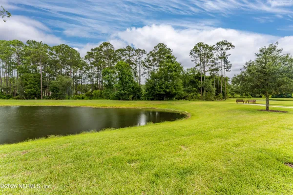 a kitchen with stainless steel appliances a sink dishwasher stove and white cabinets