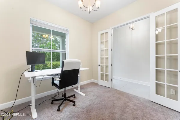 a view of a dining room and livingroom furniture wooden floor and a chandelier