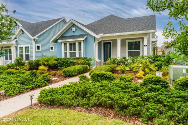 a view of a house with brick walls and flower plants
