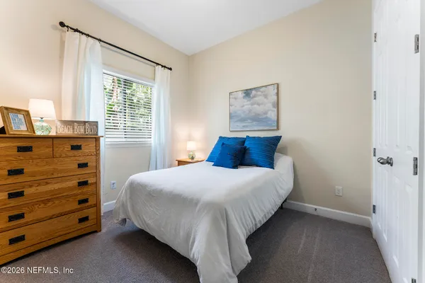 a front view of a house with a yard and outdoor seating