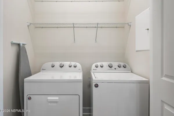 a backyard of a house with table and chairs