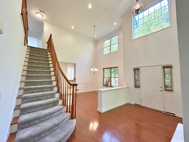 a view of an entryway with wooden floor and a livingroom