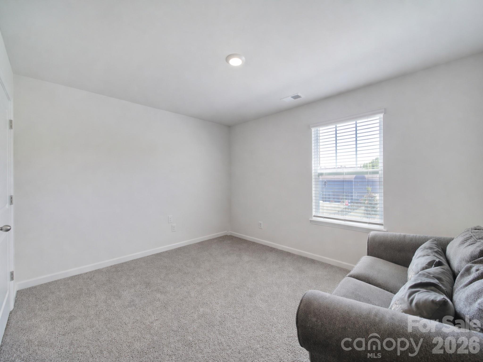 107 Spring Hall Court Troutman, NC 28166 - Photo 22 of 28 a living room with furniture and window