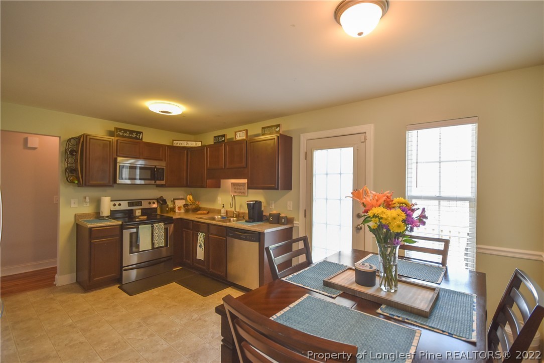 37 Jumpmaster Drive Broadway, NC 27505 - Photo 15 of 48 a kitchen with stainless steel appliances granite countertop a stove top oven a sink dishwasher and a refrigerator
