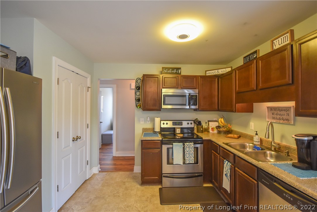 37 Jumpmaster Drive Broadway, NC 27505 - Photo 20 of 48 a kitchen with stainless steel appliances granite countertop a refrigerator stove and sink