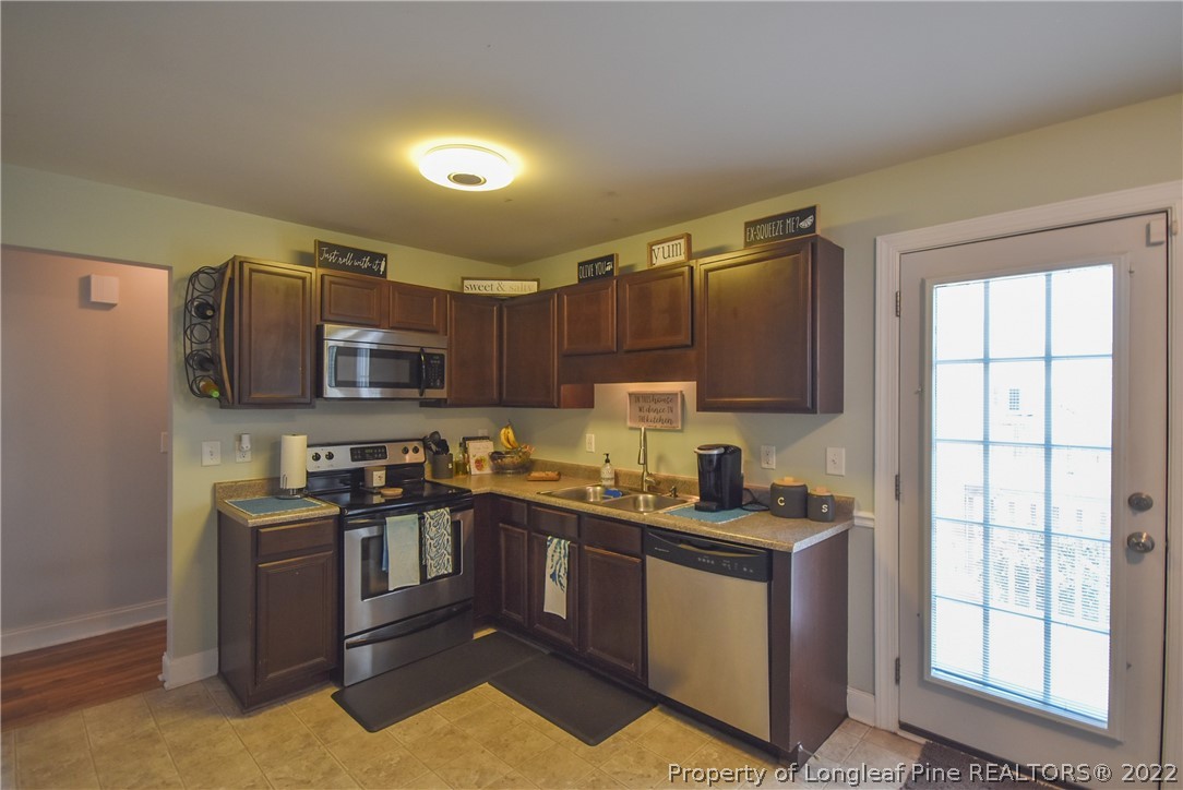 37 Jumpmaster Drive Broadway, NC 27505 - Photo 21 of 48 a kitchen with stainless steel appliances granite countertop a stove a sink dishwasher a refrigerator and a microwave