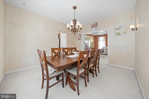 a kitchen with stainless steel appliances granite countertop a stove a sink dishwasher a refrigerator and a microwave oven with white countertops