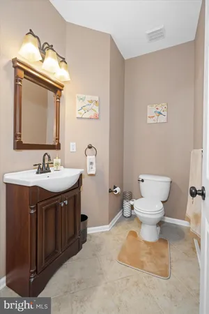 a kitchen with granite countertop a refrigerator stove top oven and sink