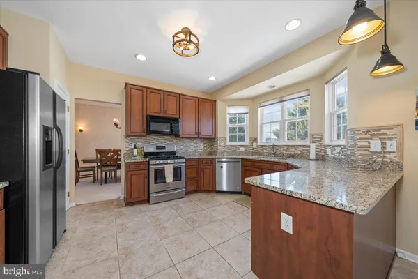 a kitchen with stainless steel appliances granite countertop sink and window