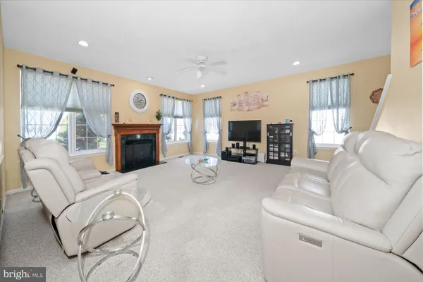 a bedroom with a bed and a ceiling fan