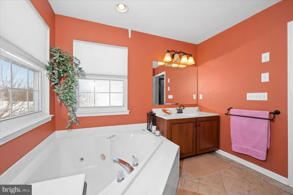 a bedroom with a bed and a wall painting