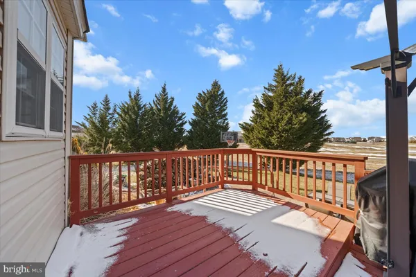 a view of a house with a yard and car parked