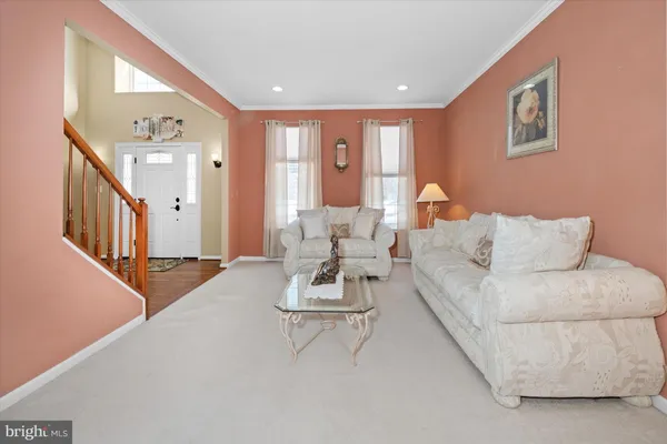 a view of a dining room with furniture and a chandelier