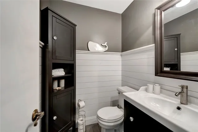 a bathroom with a sink a toilet and mirror