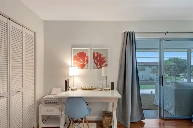 a view of a dining room with a table and chairs