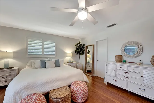 a bedroom with a large bed and a dresser