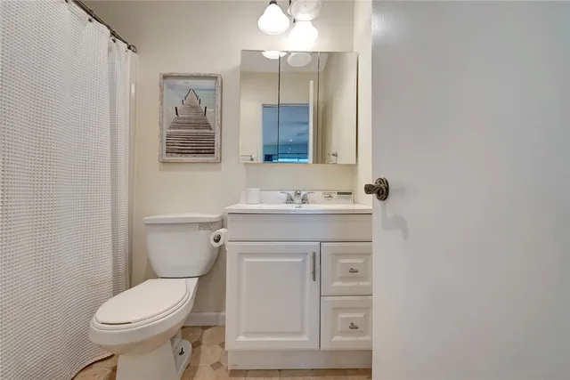 a bathroom with a sink toilet and mirror