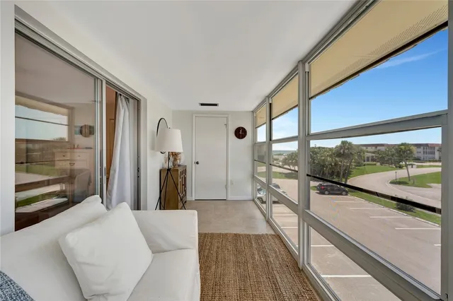 a view of a living room hardwood floor and a large window