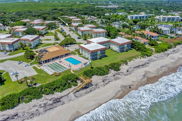 an aerial view of residential houses with outdoor space