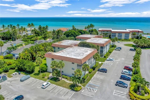 a view of a patio with furniture and a garden
