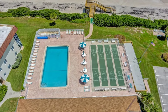 an aerial view of a house with yard swimming pool and outdoor seating
