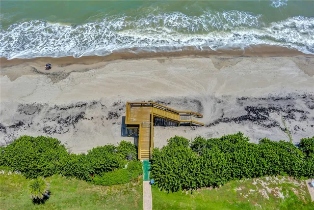 a aerial view of ocean with beach
