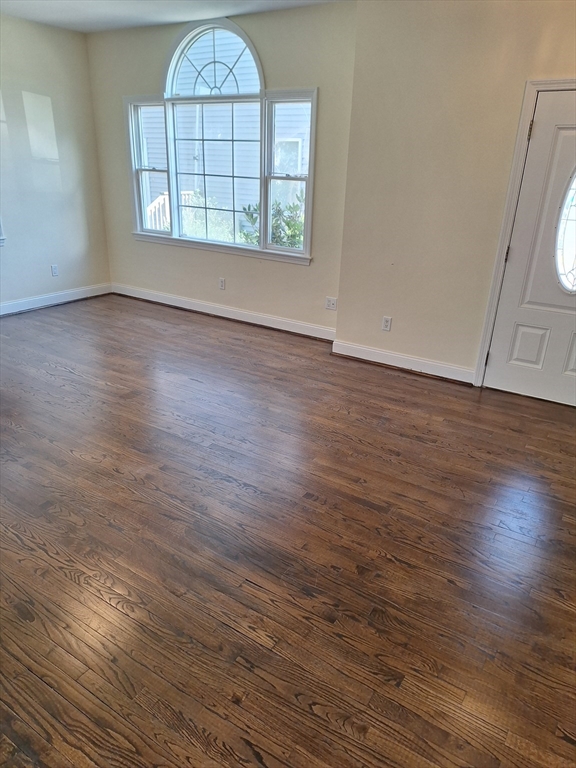 23 Ridgeway Court, Unit 23 Brockton, MA 02301 - Photo 3 of 3 an empty room with wooden floor fan and windows