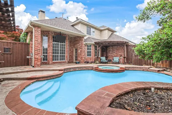 a view of a house with swimming pool and sitting area