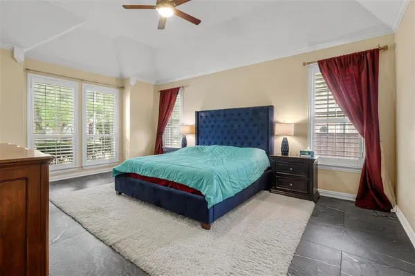 a bed sitting in a bedroom next to a window