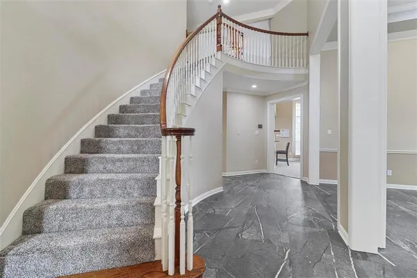 a view of staircase with white walls and windows