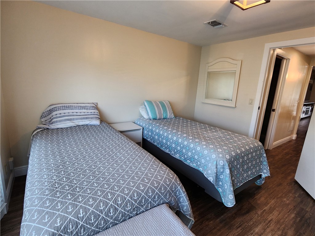 256 Bimini Cay Circle Vero Beach, FL 32966 - Photo 25 of 35 a bedroom with a bed and a large mirror on dresser