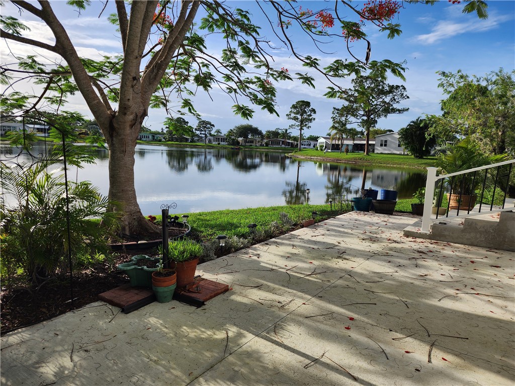 256 Bimini Cay Circle Vero Beach, FL 32966 - Photo 31 of 35 a view of a garden with a bench in patio