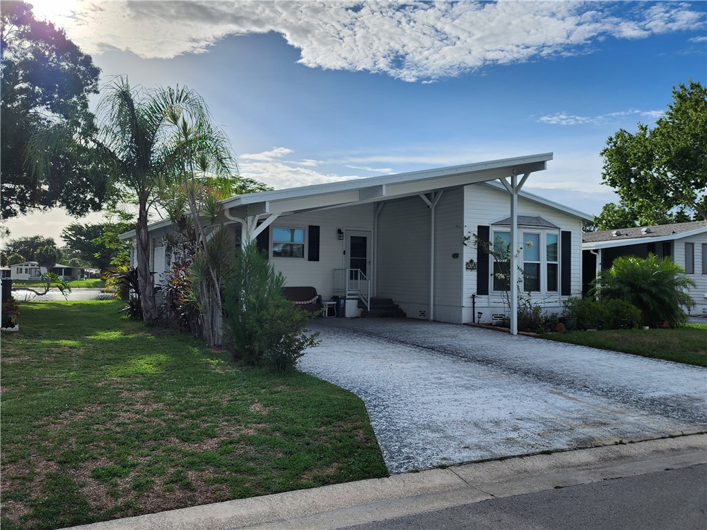 256 Bimini Cay Circle Vero Beach, FL 32966 - Photo 4 of 35 a front view of a house with garden