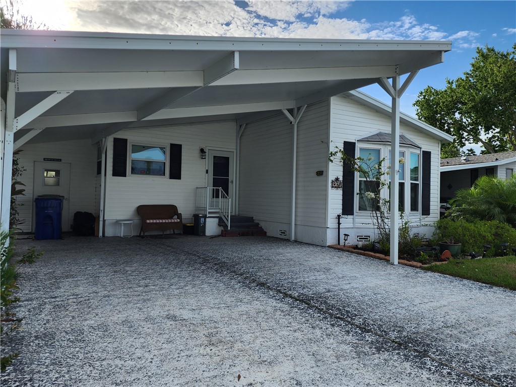 256 Bimini Cay Circle Vero Beach, FL 32966 - Photo 5 of 35 a view of a house with a backyard and garage