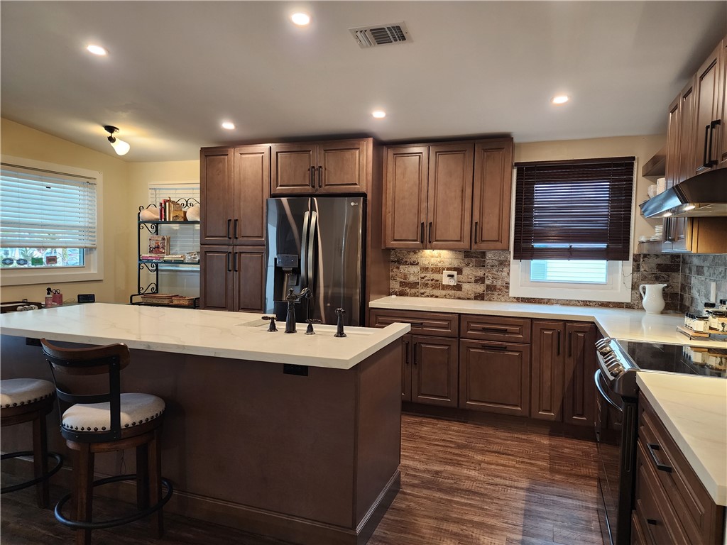 256 Bimini Cay Circle Vero Beach, FL 32966 - Photo 7 of 35 a kitchen with stainless steel appliances granite countertop a sink stove and refrigerator
