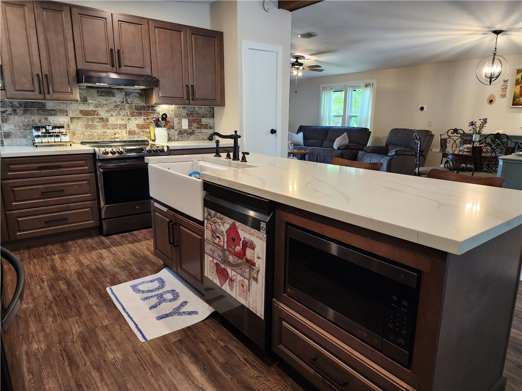 256 Bimini Cay Circle Vero Beach, FL 32966 - Photo 10 of 35 a kitchen with stainless steel appliances granite countertop a sink stove and cabinets