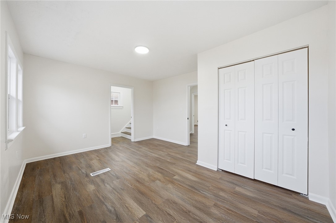 7911 Snow Road Parma, OH 44129 - Photo 28 of 44 Unfurnished bedroom featuring dark wood-type flooring and a closet