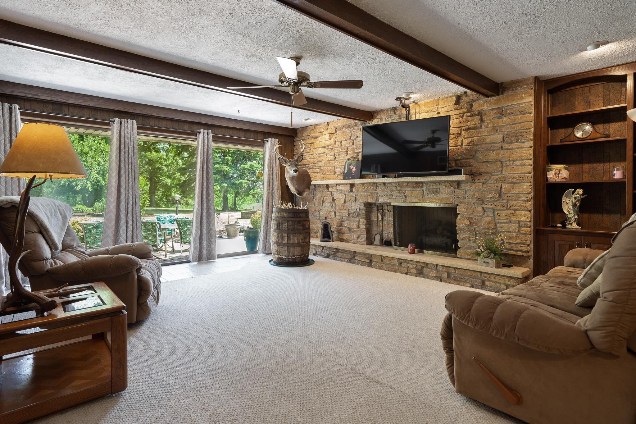 4470 North Cockrell Road Freeport, IL 61032 - Photo 72 of 99 a living room with furniture a flat screen tv and a fireplace
