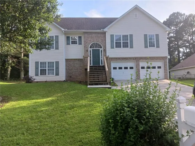 a front view of a house with a garden