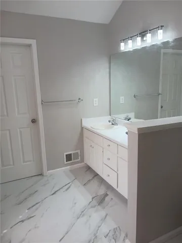 a spacious bathroom with a double vanity sink a mirror and a shower