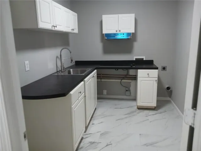a kitchen with a sink and cabinets