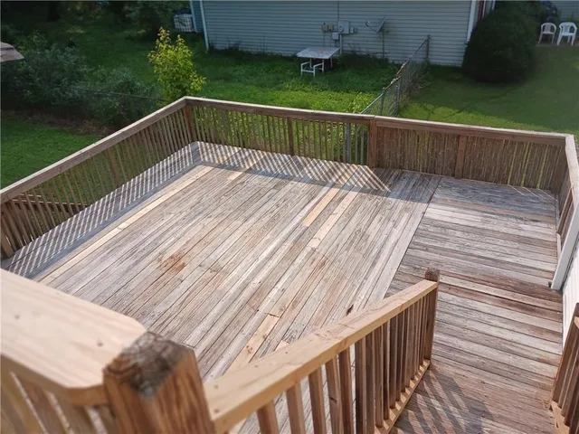 a view of balcony with wooden floor and outdoor seating