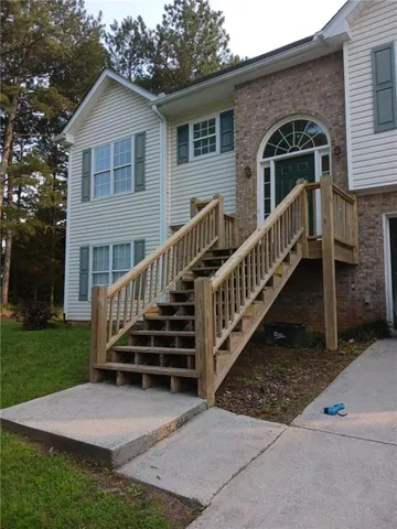 a view of house with a yard from a patio