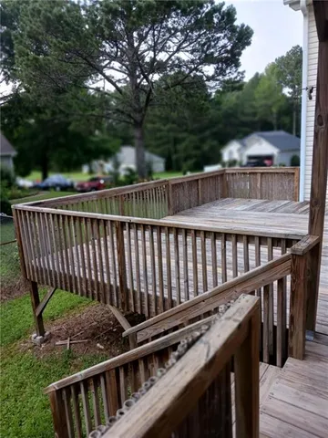 a view of a wooden deck and a yard