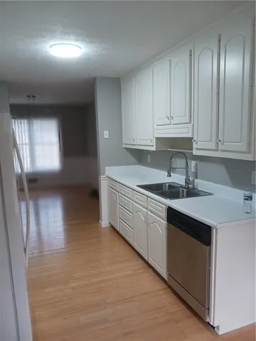 a kitchen with granite countertop a sink and cabinets