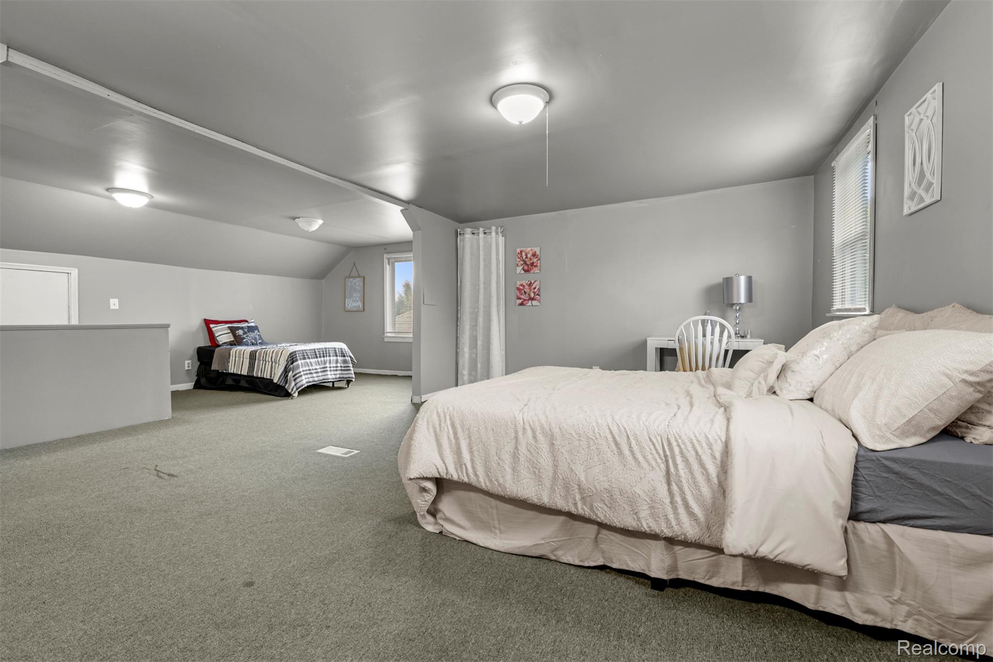 6780 Rutland Street Detroit, MI 48228 - Photo 24 of 35 Spacious room with sloped ceilings, recessed lighting, and soft gray carpeting