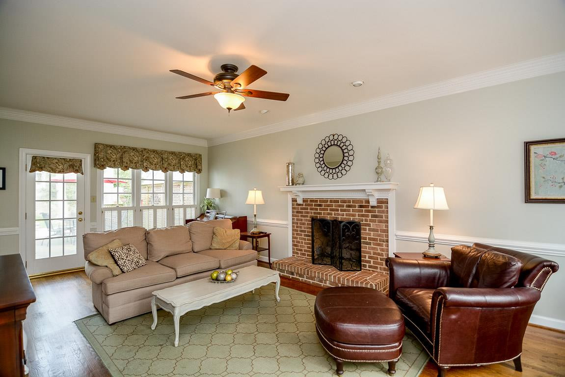 Hardwood floors, heavy crown molding and smooth ceilings. Gas fireplace with impressive brick hearth and mantel. Large windows with plantation shutters. Family Room