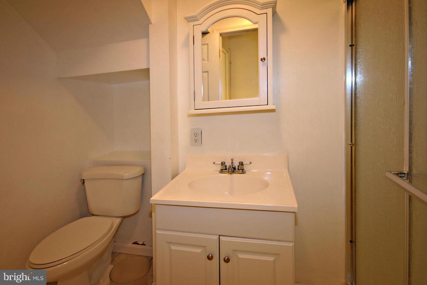 14416 Old Stage Road Bowie, MD 20720 - Photo 13 of 24 a bathroom with a toilet sink and mirror